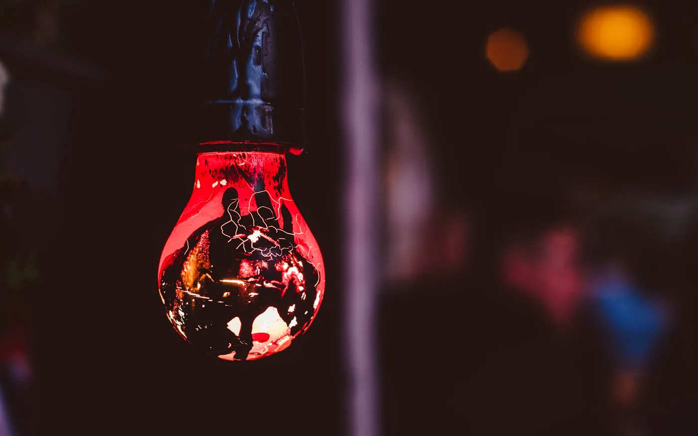 An old red bulb hanging amongst the rafters at Copenhagen Street Food Market., by Shane Rounce (Ace Media)